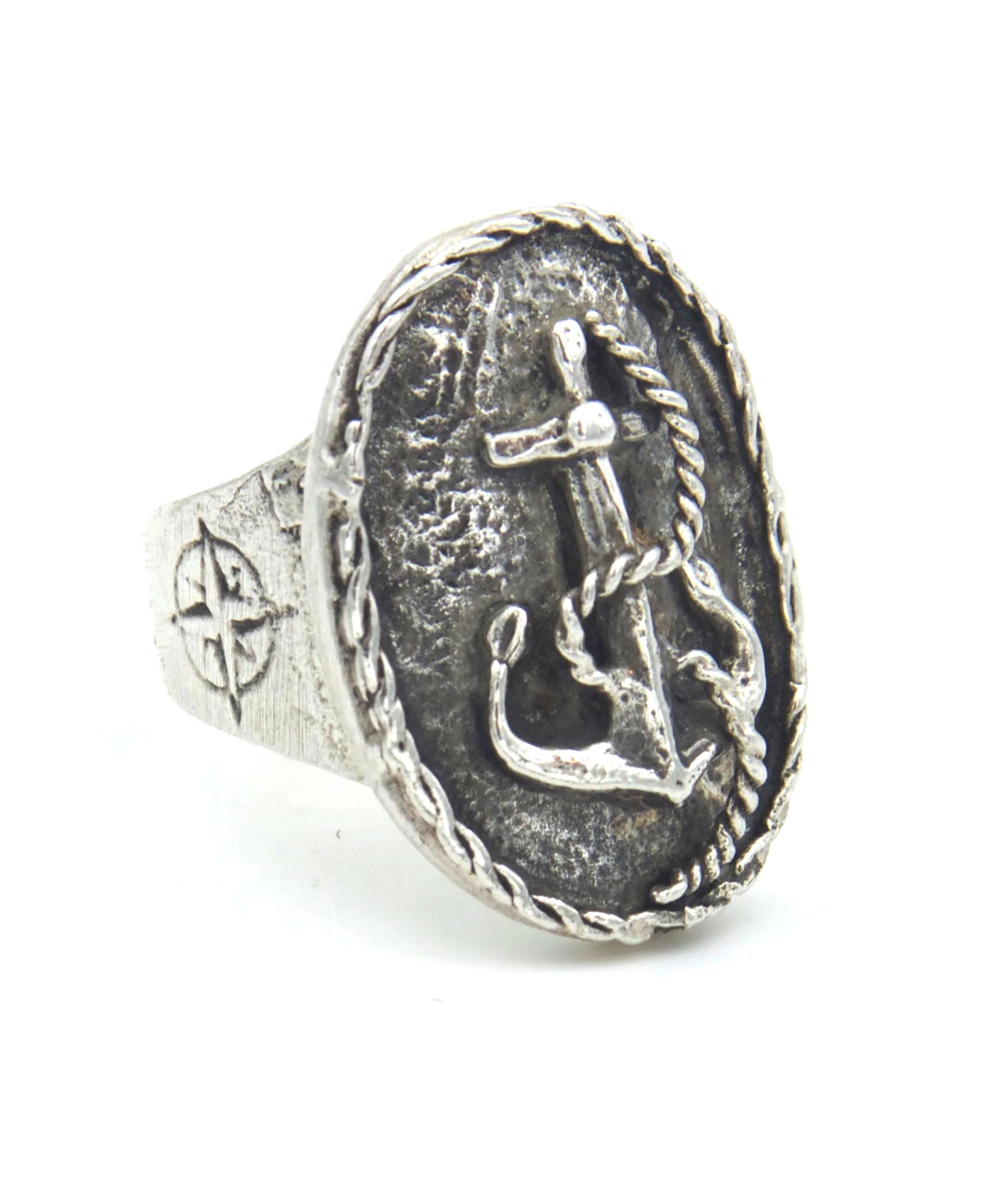 Silver ring with anchor and sword design on a white background