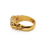 Gold ring with a textured band on a white background