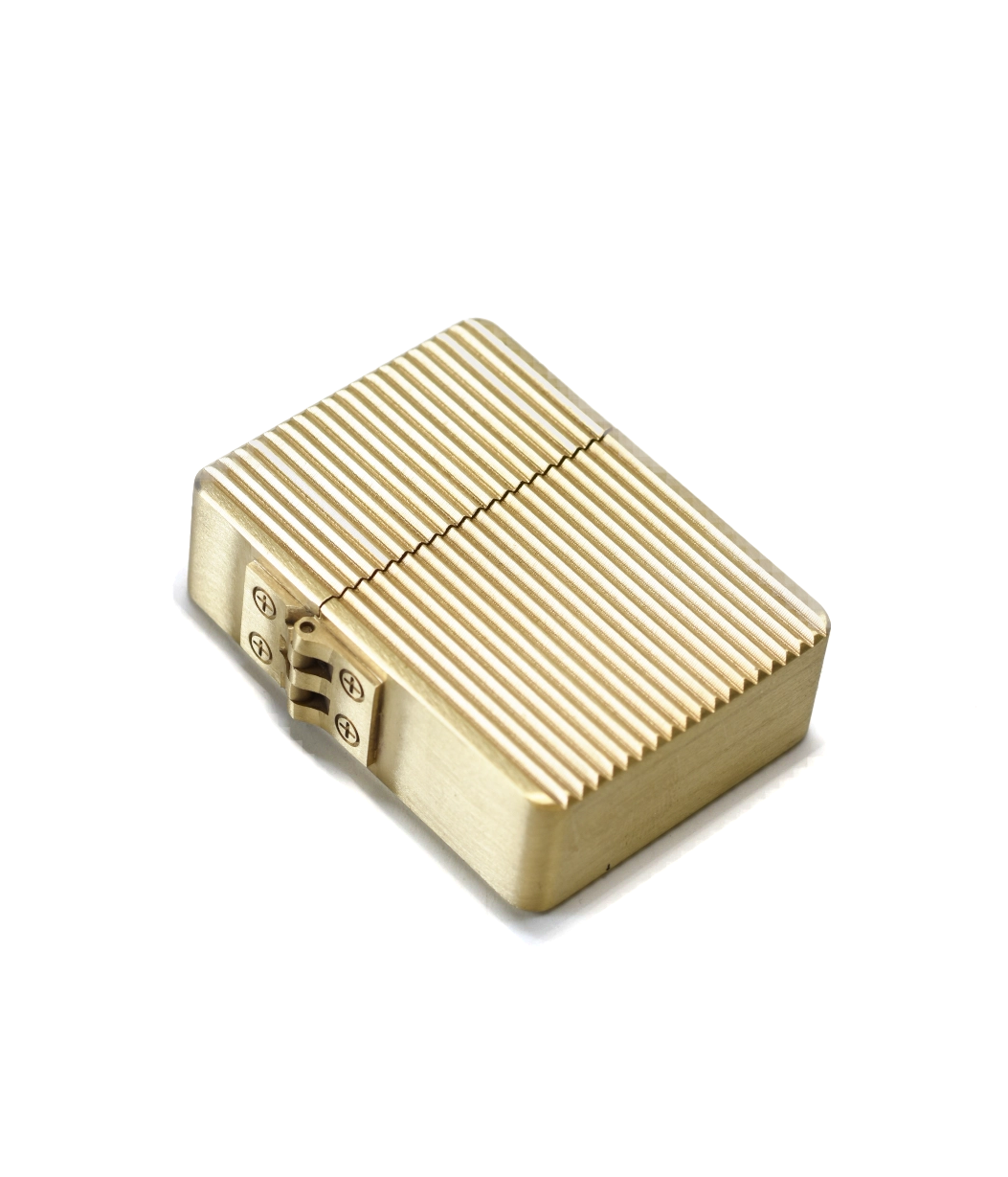 Gold lighter with textured surface on a white background