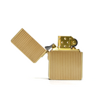 Gold lighter with open lid on a white background
