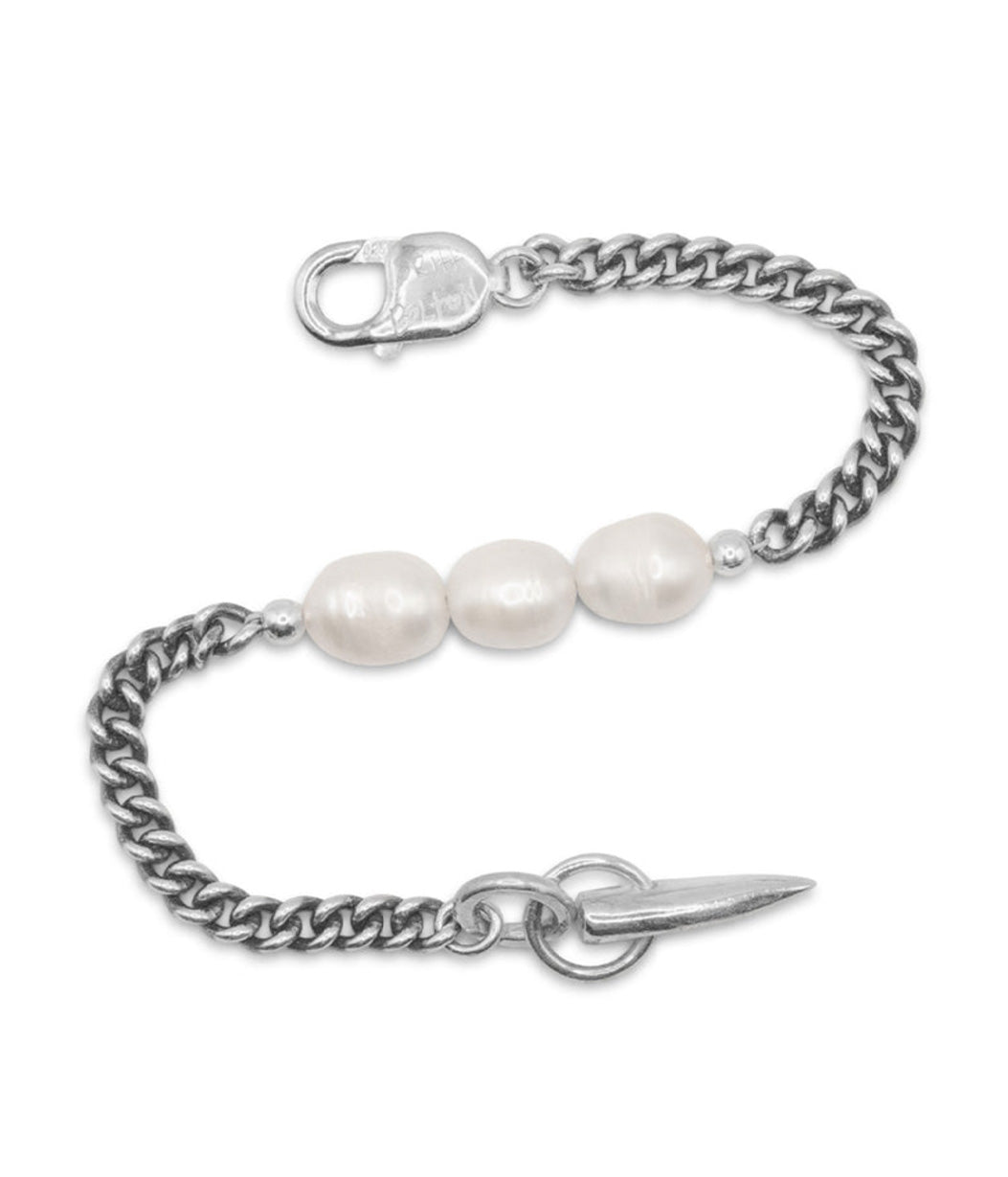 Silver chain bracelet with three pearls on a white background