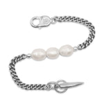 Silver chain bracelet with three pearls on a white background