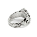 Silver ring with a textured surface on a white background