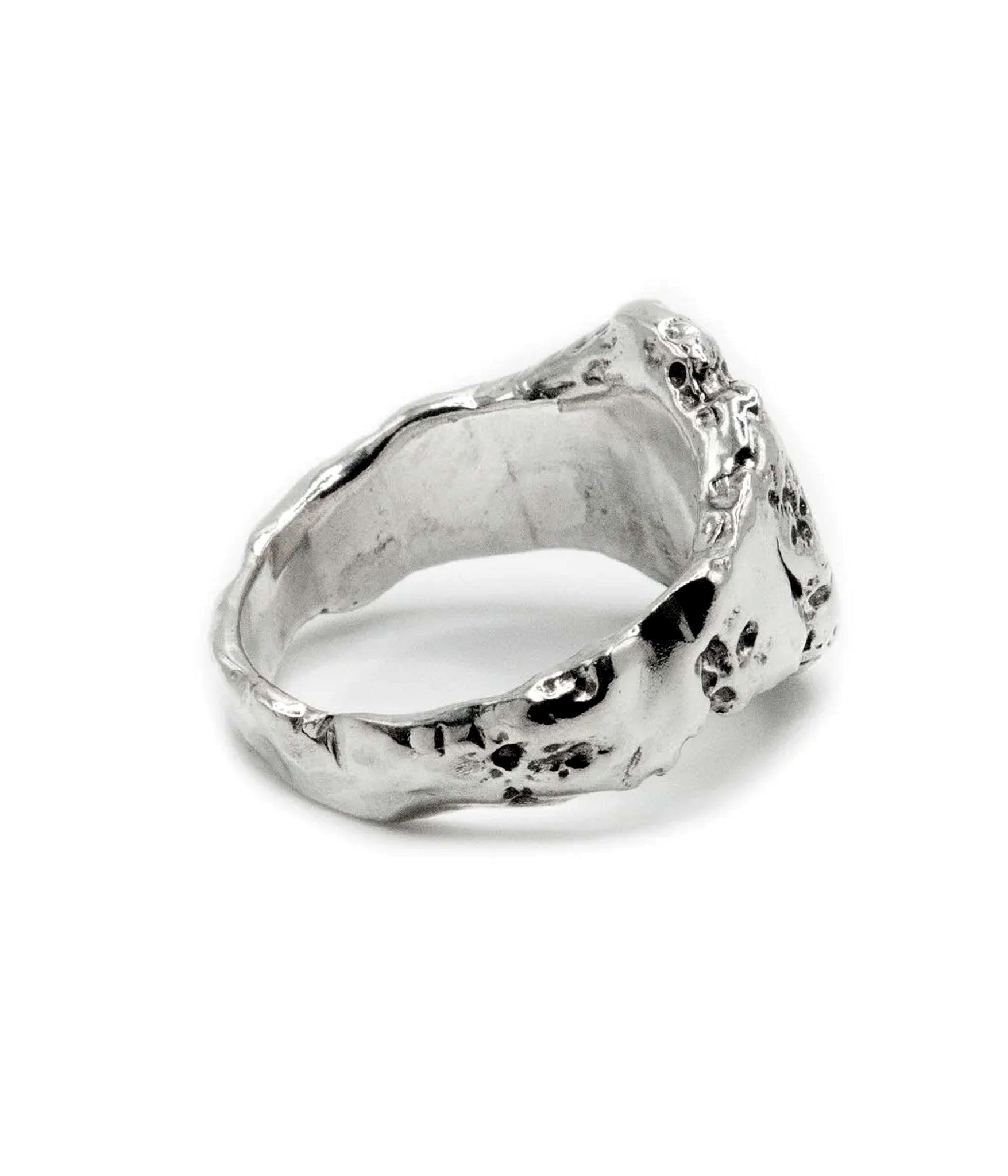 Silver ring with a textured surface on a white background