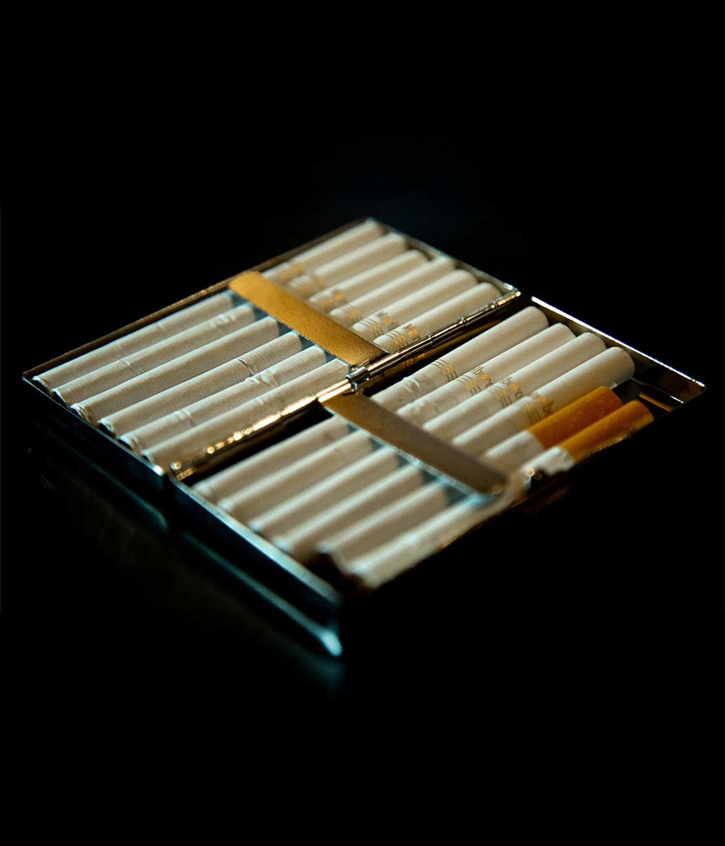 Cigarette pack with cigarettes on a dark background