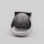 Silver ring with '925' and '24K' stamp on a light gray background