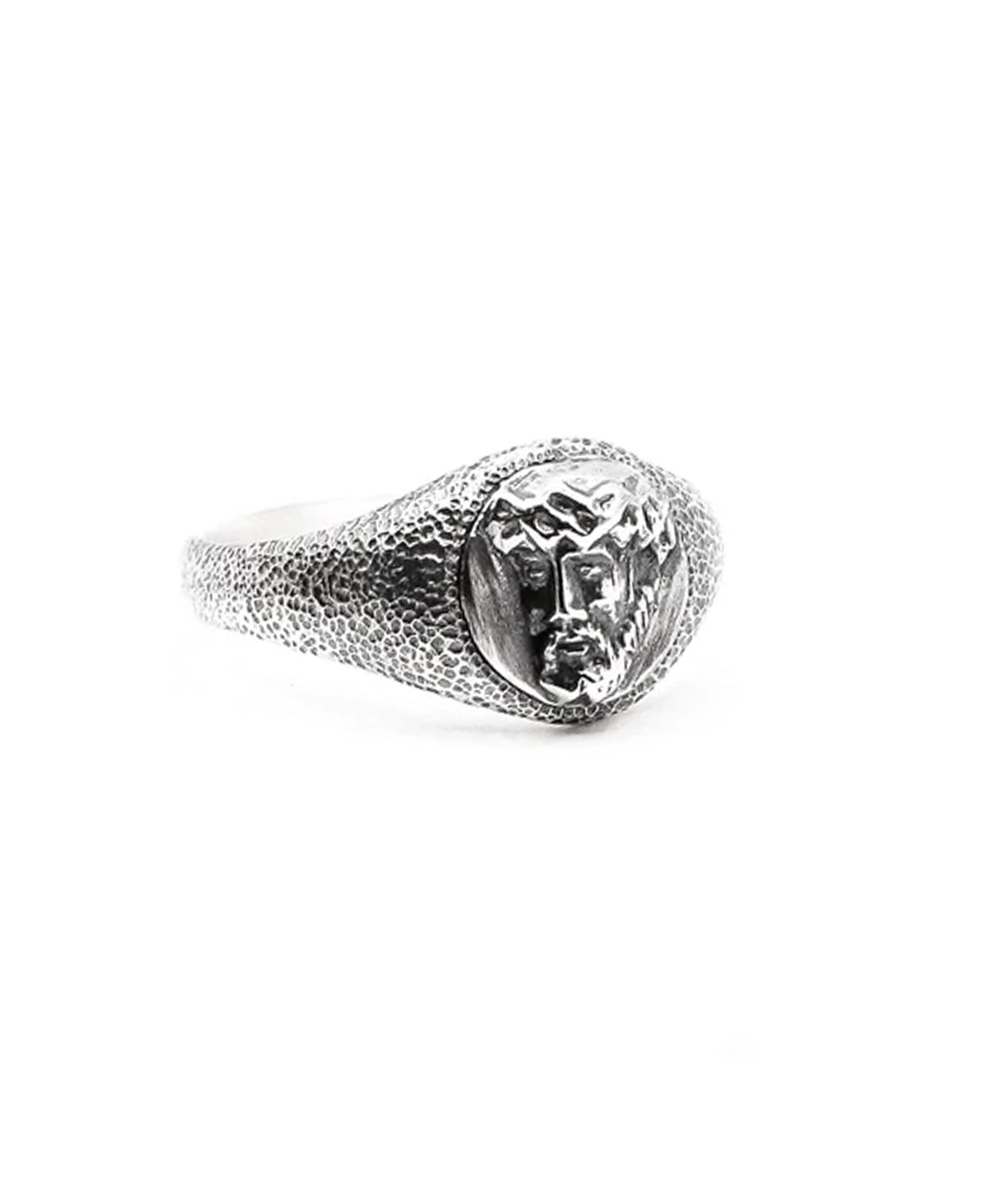 Silver ring with a textured band and clear gemstone on a white background