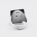 Silver ring with '925' stamp on a white background