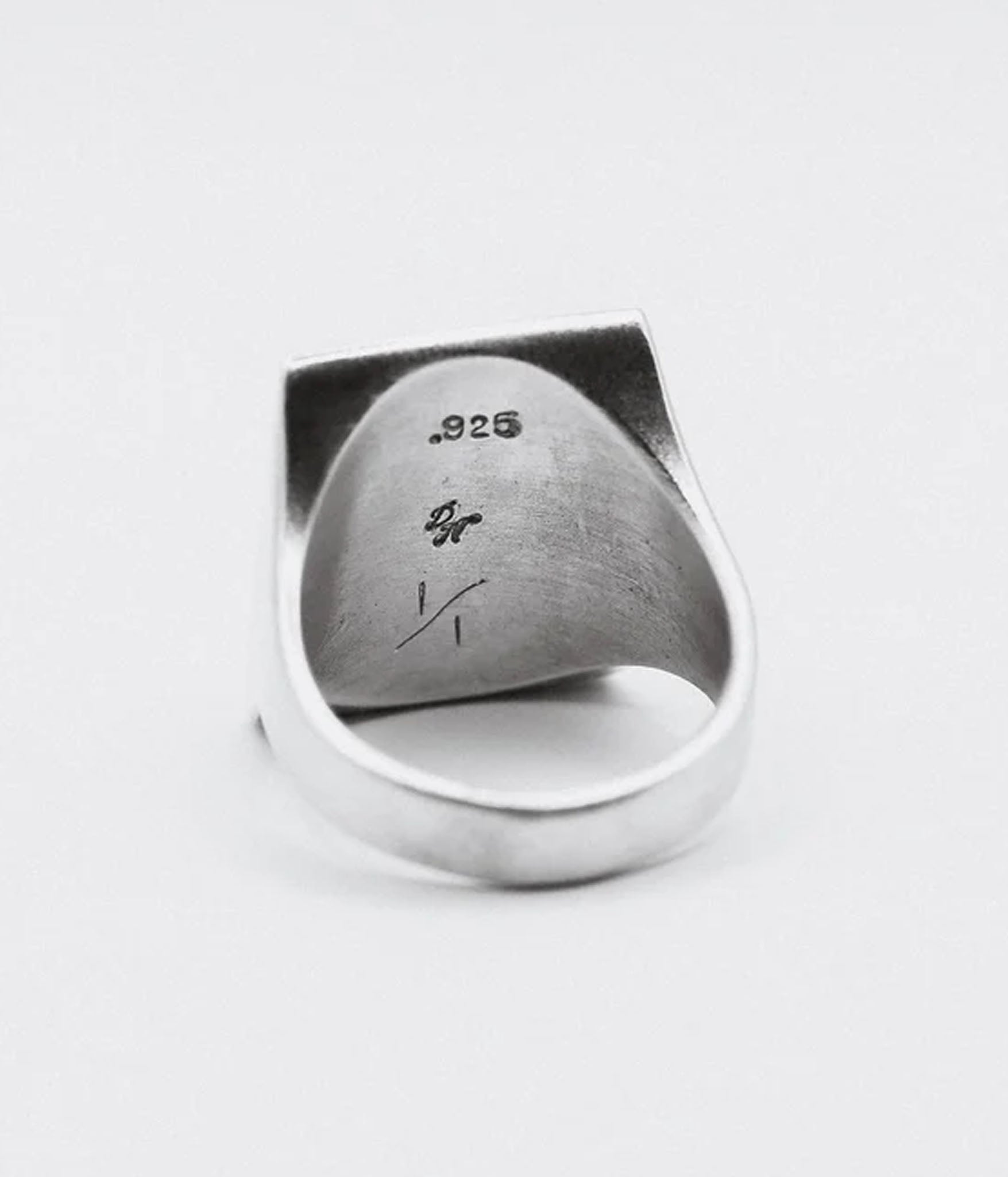 Silver ring with '925' stamp on a white background