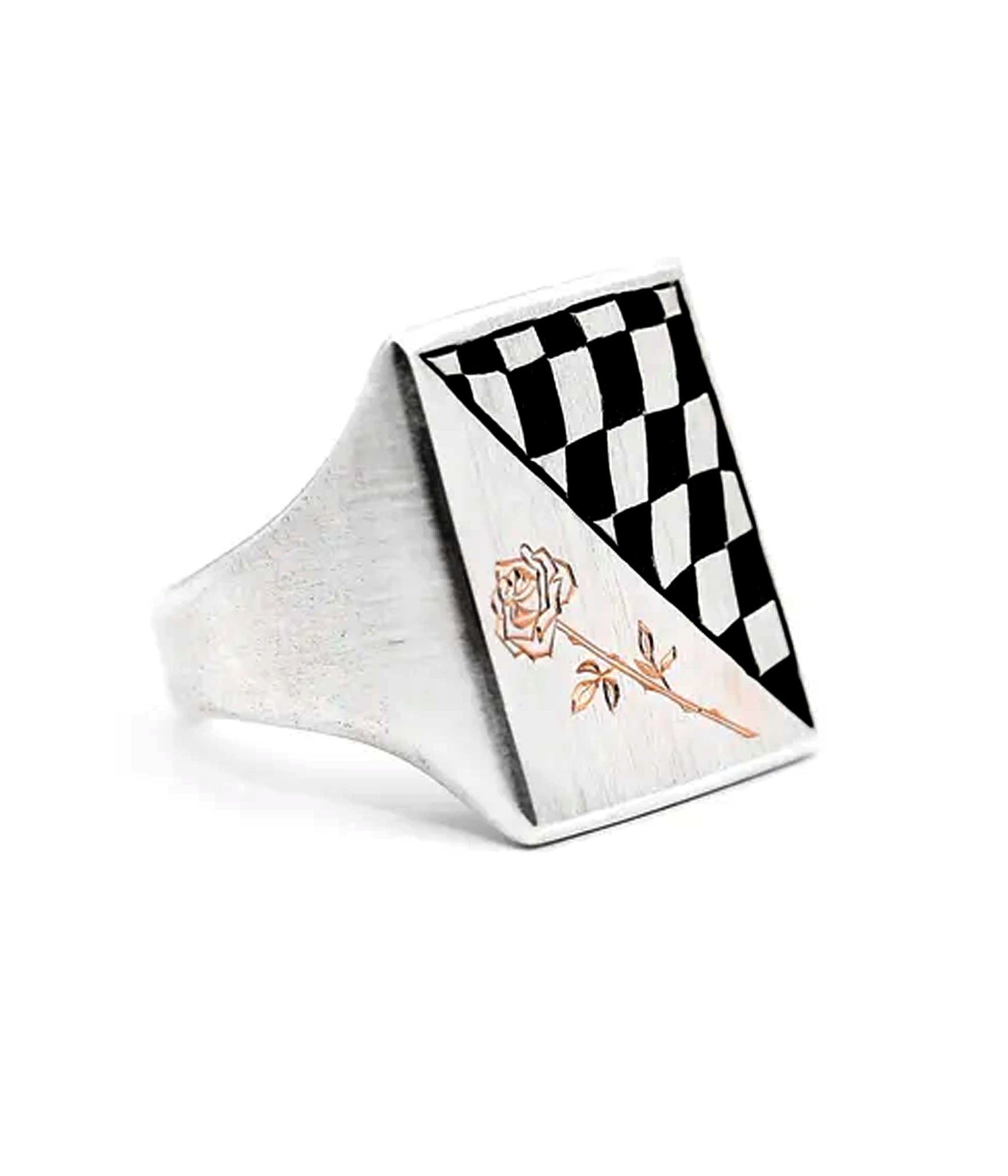 Silver ring with black and white checkered design and rose engraving on a white background