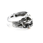 Silver ring with a detailed design on a white background