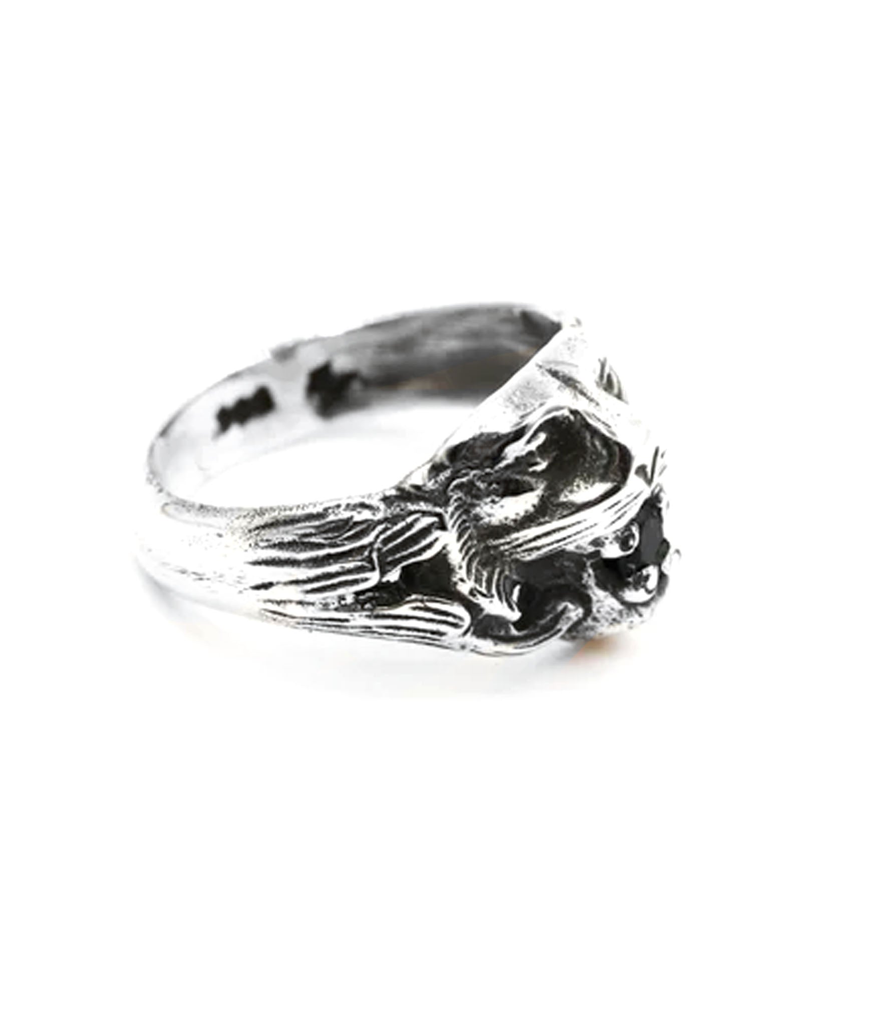 Silver ring with a detailed design on a white background