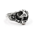Front view of silver tiger ring with fierce facial detailing and black onyx gemstone between fangs