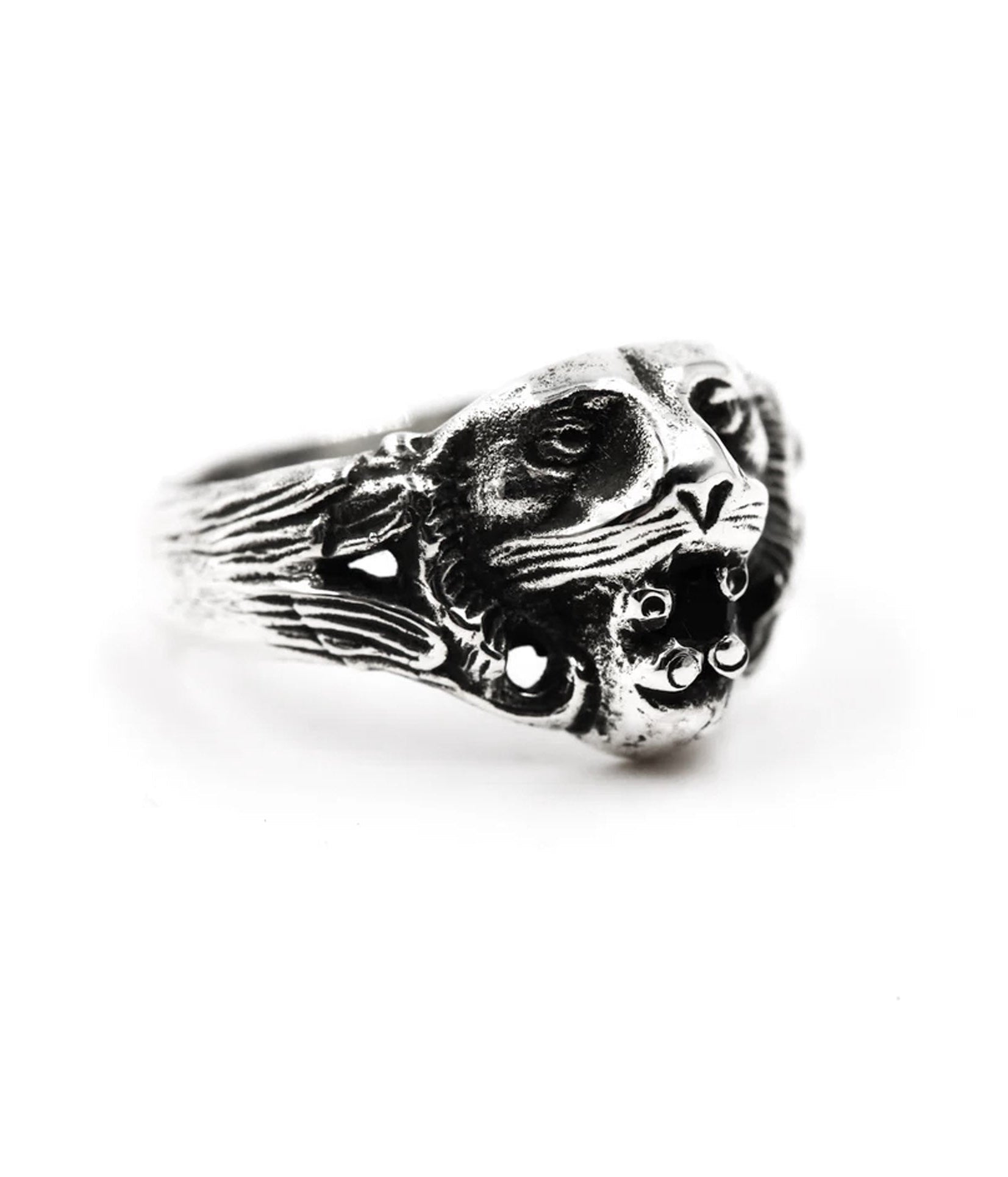 Front view of silver tiger ring with fierce facial detailing and black onyx gemstone between fangs