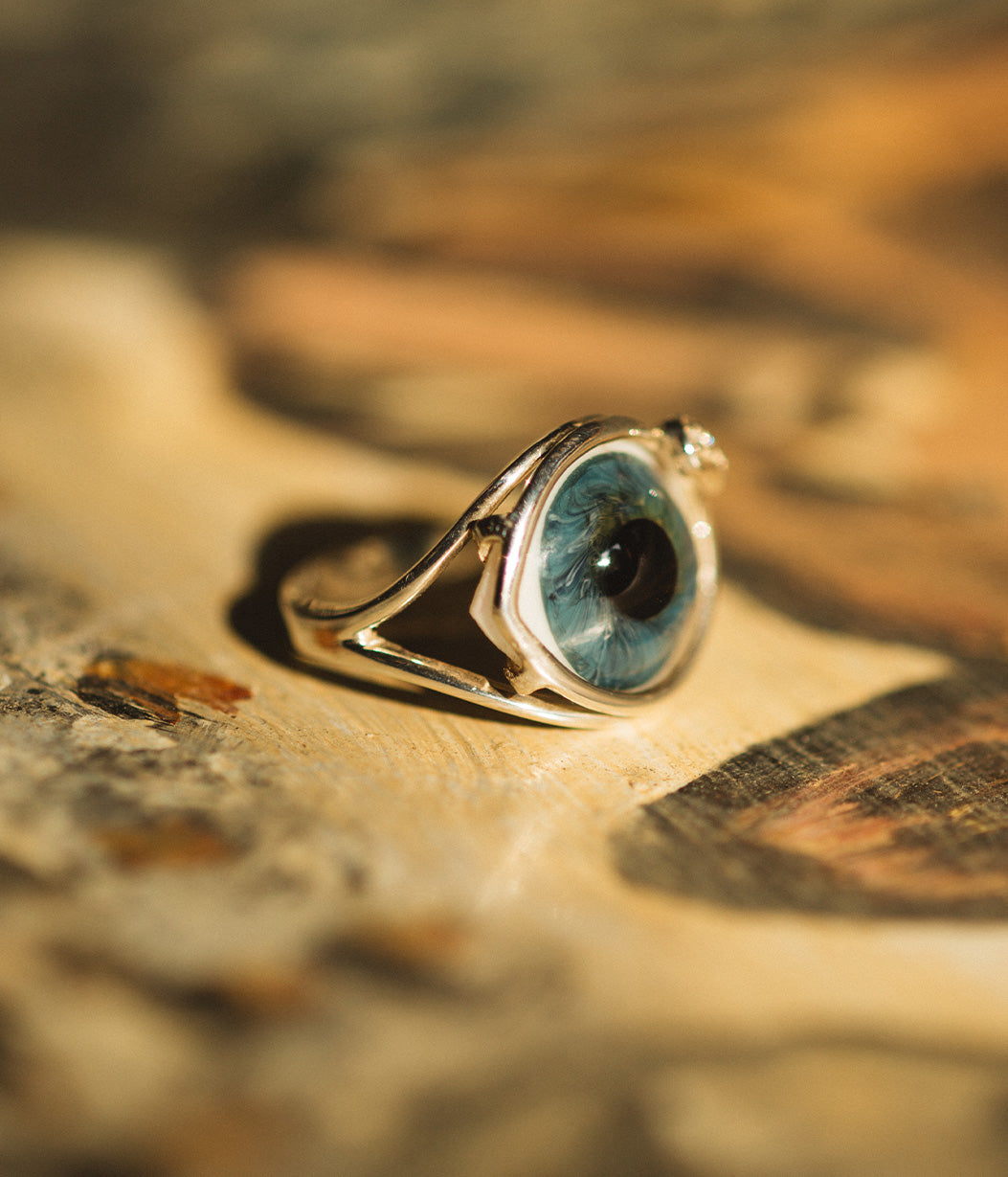 Ring with a blue stone on a textured surface