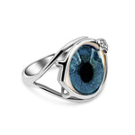 Silver ring with a blue gemstone on a white background