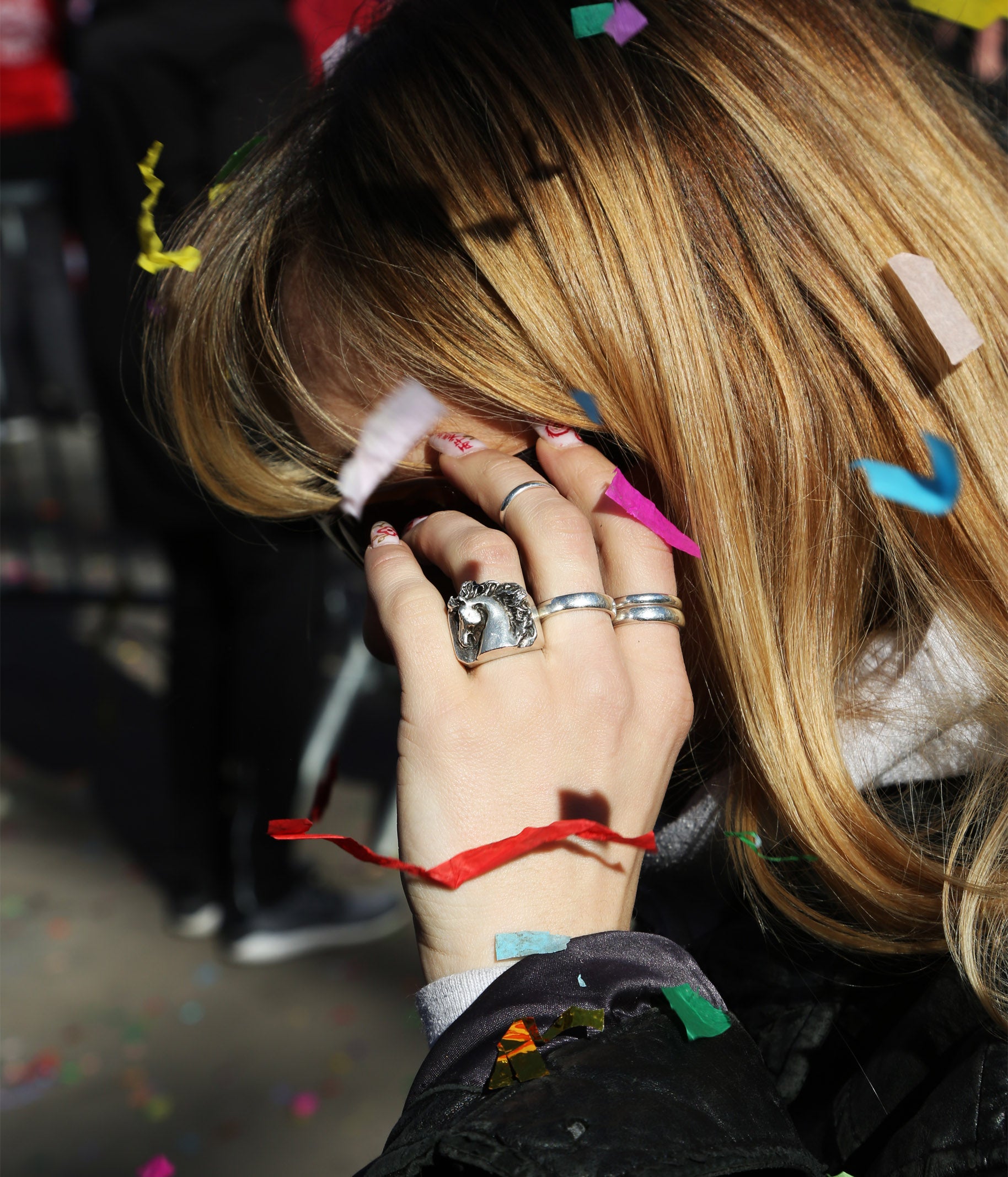Person with colorful hair clips and rings on a blurred background