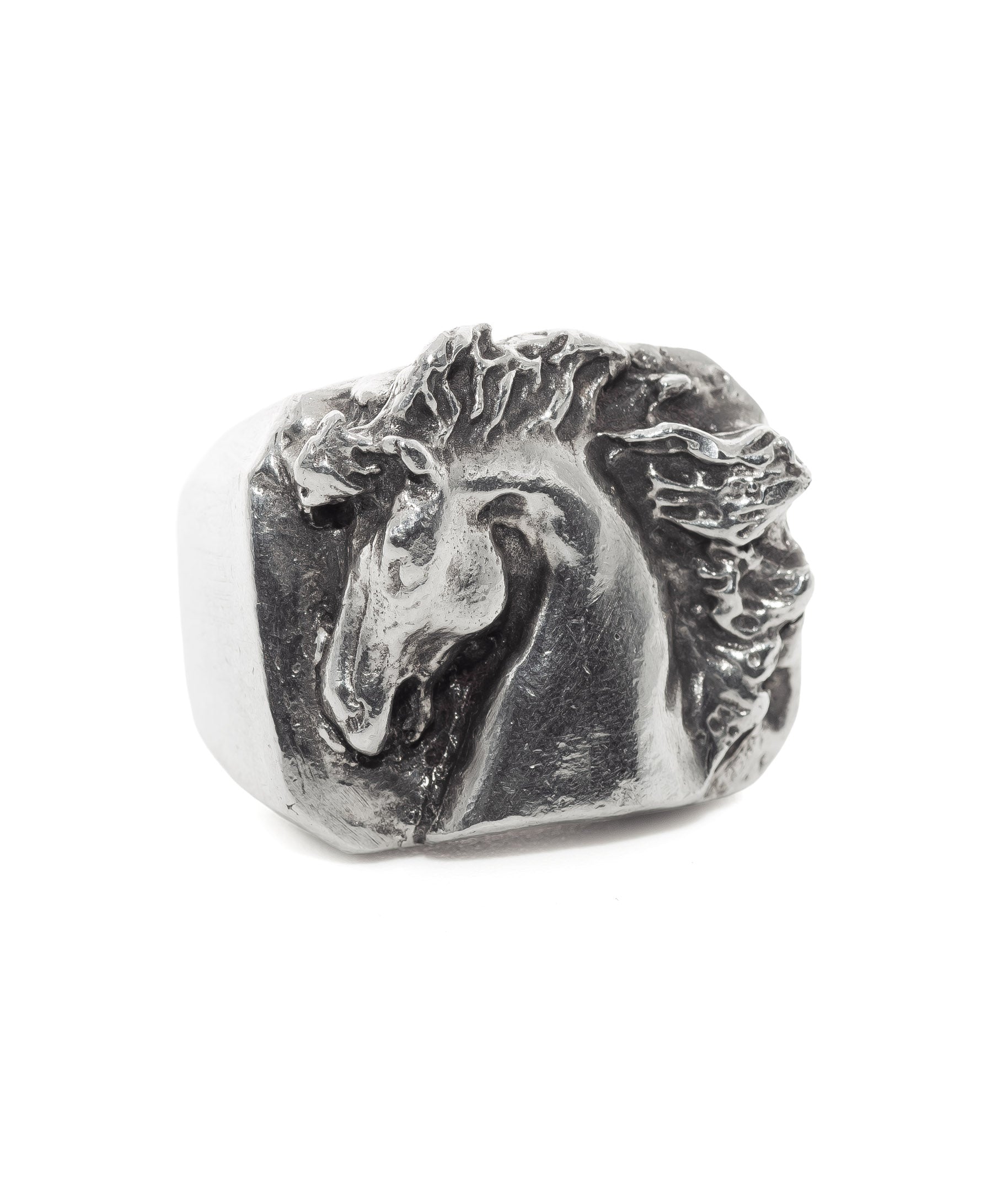 Silver horse head ring on a white background