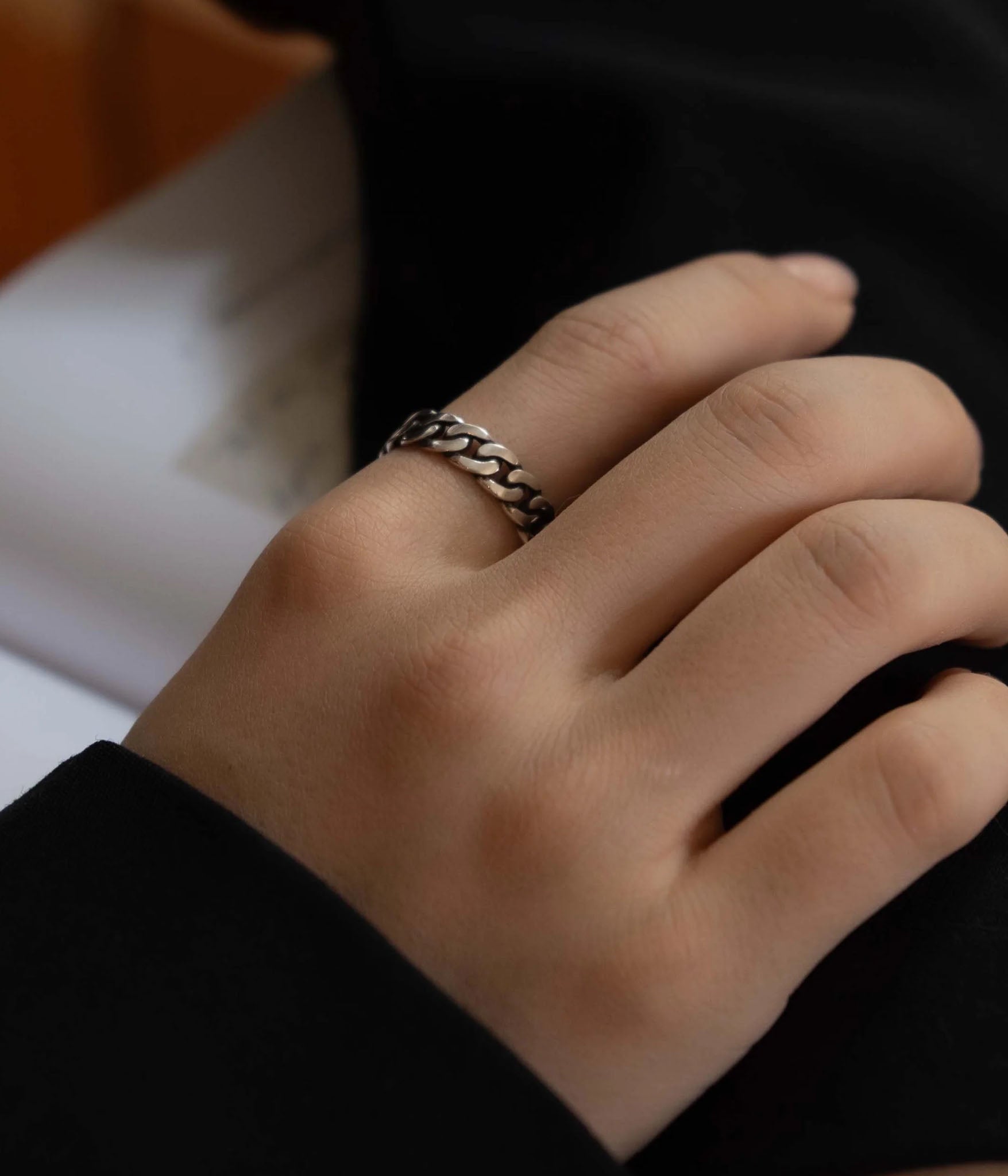 Closeup of THE HUNT NYC FUTABA Cuban Ring worn on model's finger, showcasing polished silver finish and handcrafted chain design