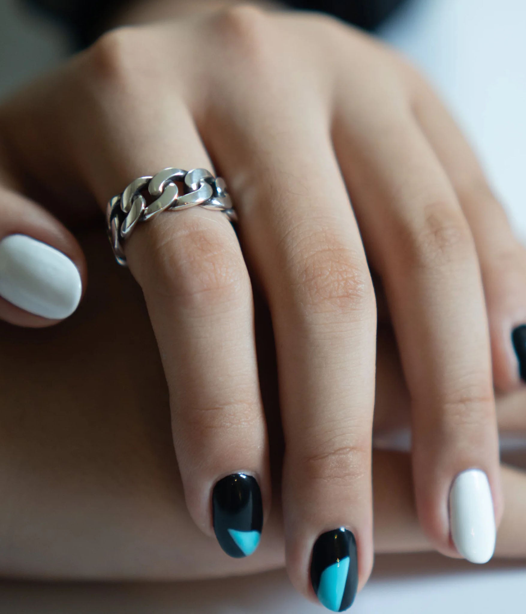 Closeup of THE HUNT NYC FUTABA Cuban Ring worn on model's finger, showcasing polished silver finish and handcrafted chain design