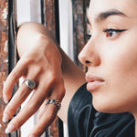 “Close-up of model wearing THE HUNT NYC FUTABA Cuban ring in polished silver, styled with minimal makeup and natural light—handcrafted unisex jewelry shot by window.”