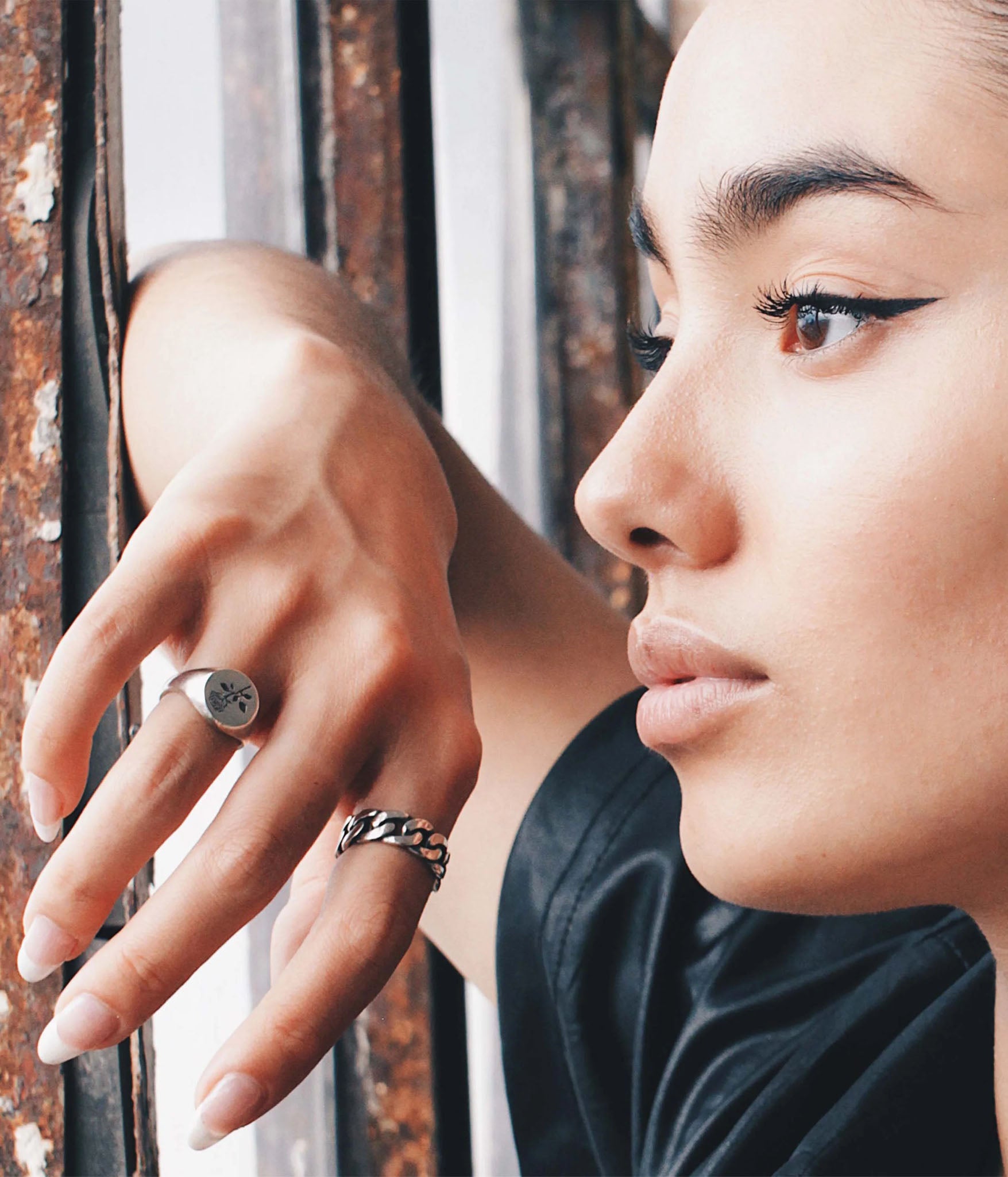 “Close-up of model wearing THE HUNT NYC FUTABA Cuban ring in polished silver, styled with minimal makeup and natural light—handcrafted unisex jewelry shot by window.”