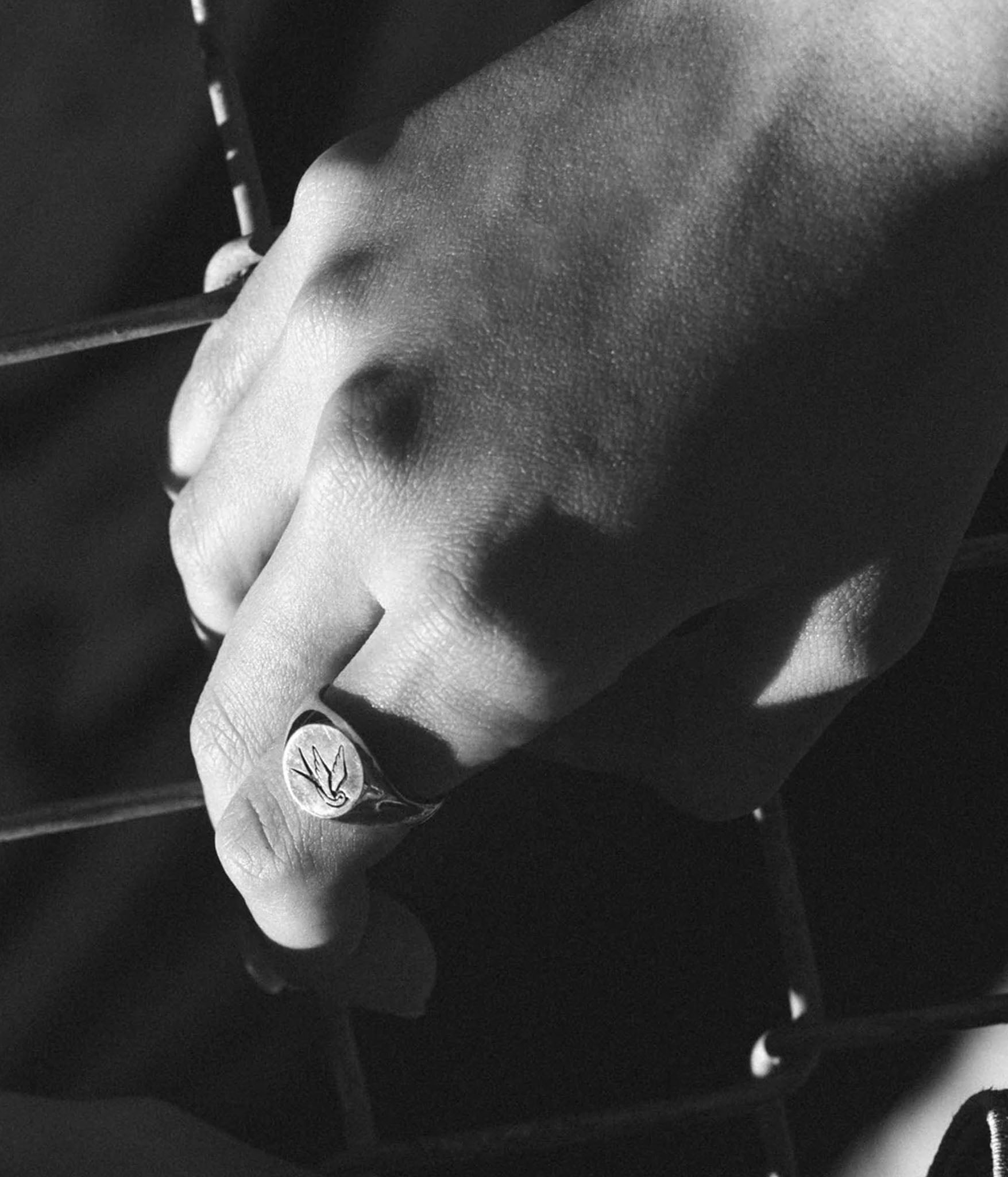 swallow signet on hand in black and white 