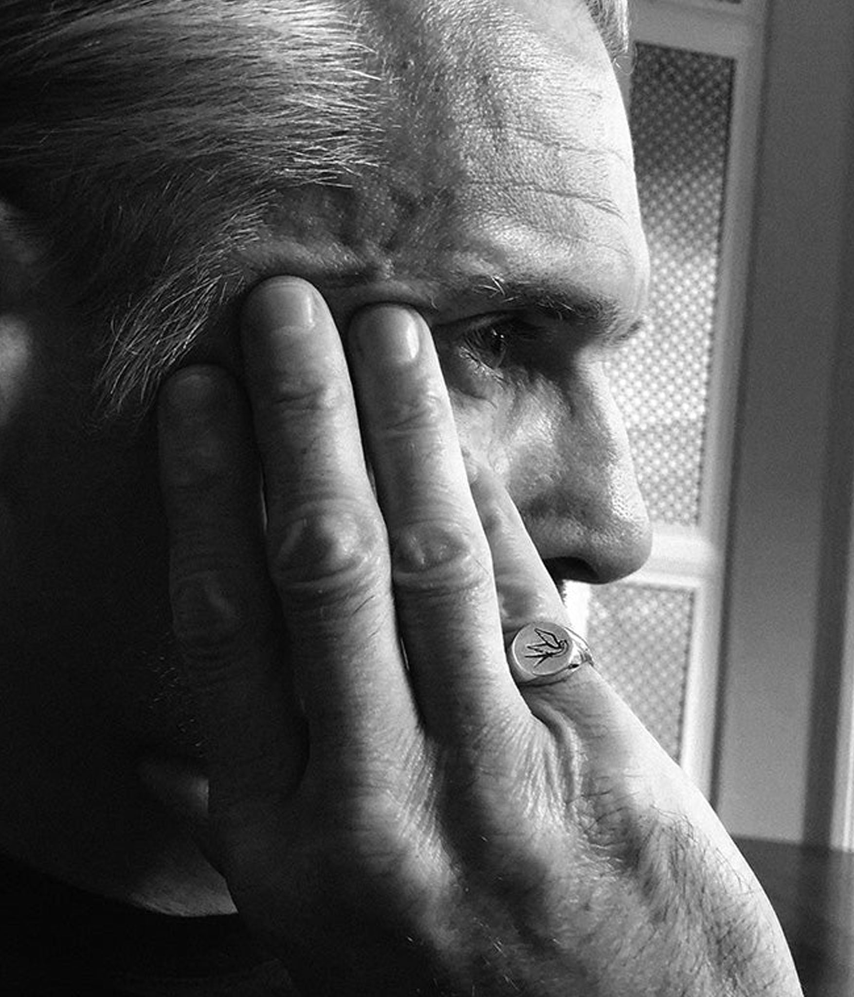 silver swallow signet worn on the pinky on male model in black and white 