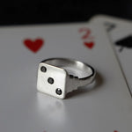 sterling silver vintage inspired dice signet with 3 diamonds shot on top of a deck of cards