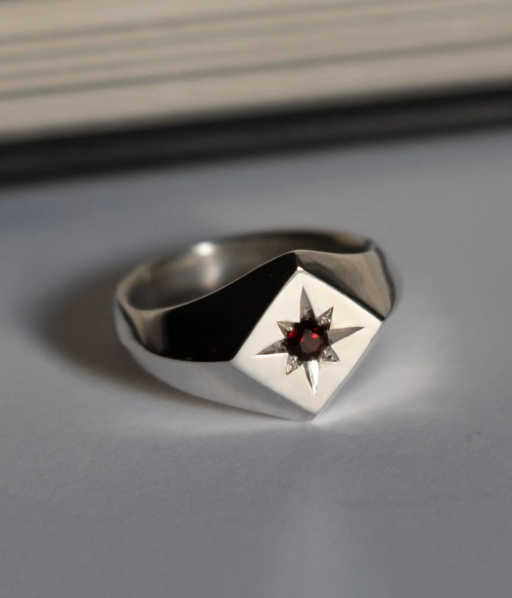 north star signet ring with red garnet 