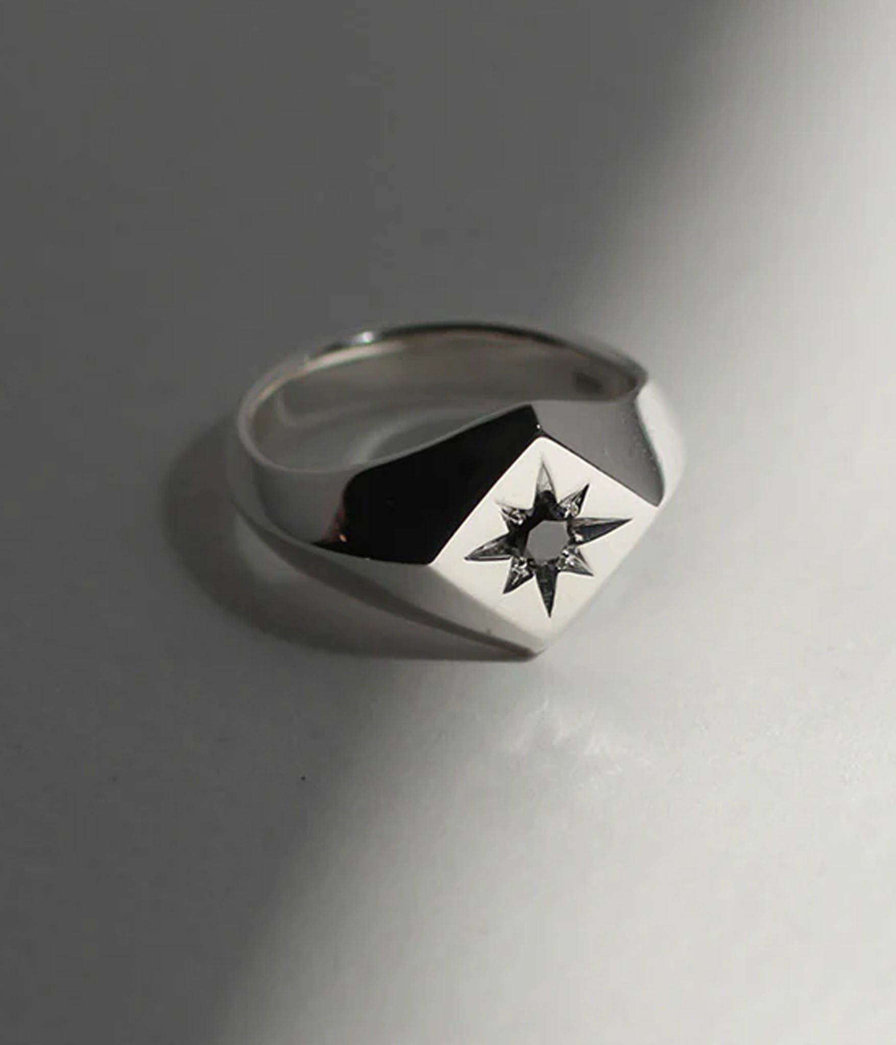 square north star signet ring with black diamond with harsh light 