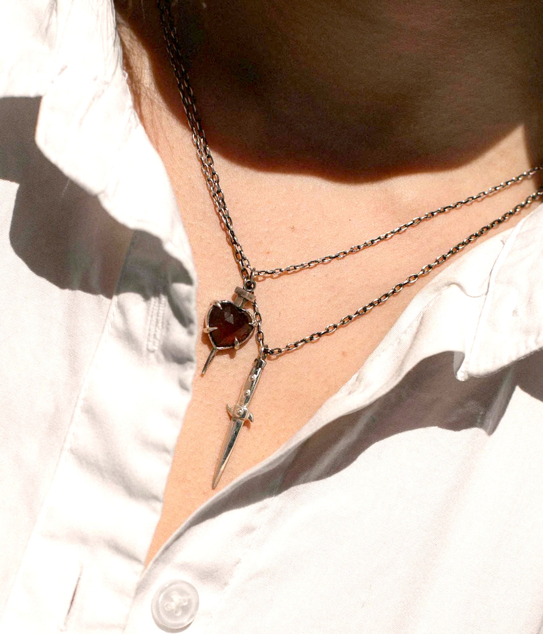 silver switchblade necklace on model 