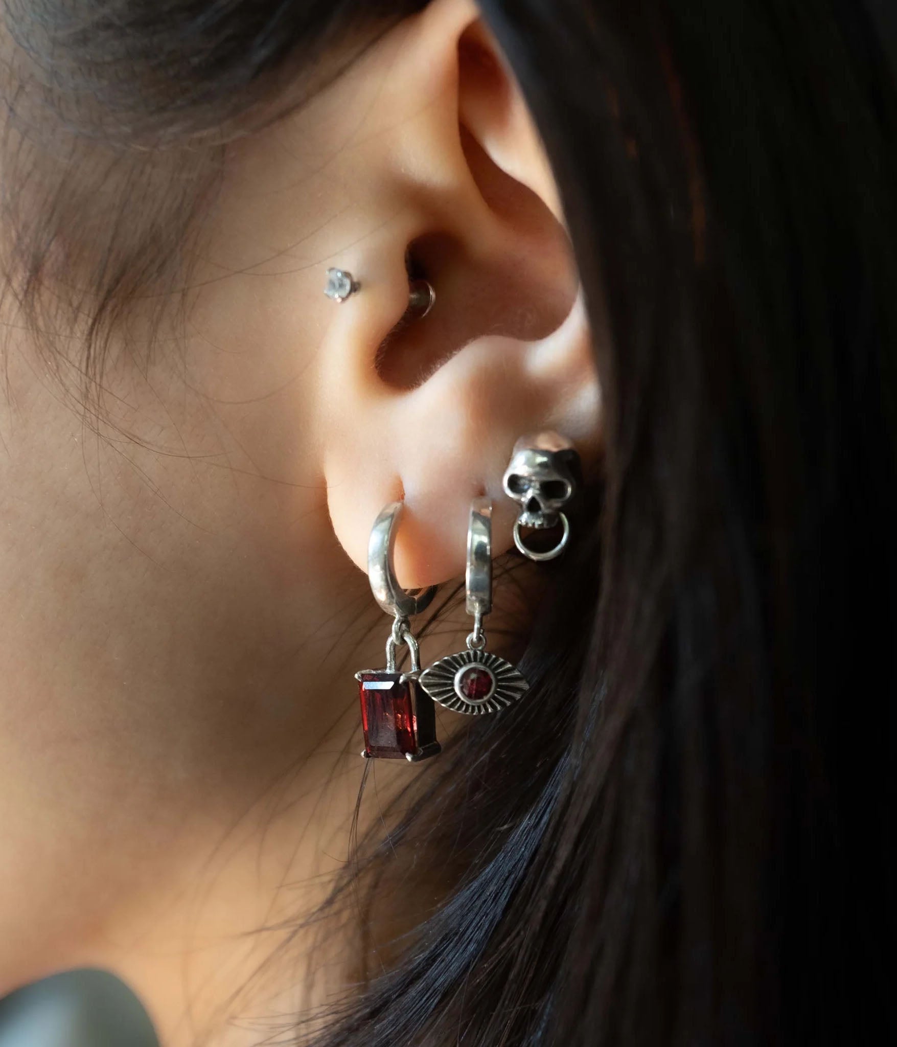 Sterling Silver and red Garnet Evil Eye Earring on Model 