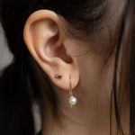 gold and ruby spike stud earring on ear