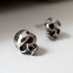 Close up shot of sterling silver skull stud earring