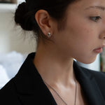 silver skull door knocker earring on model, side view