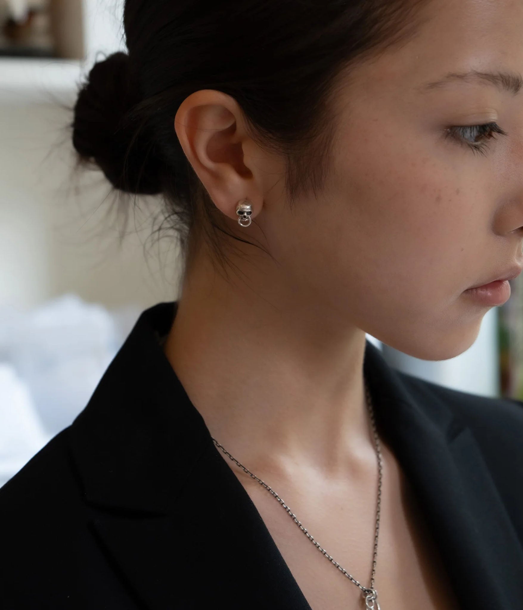 silver skull door knocker earring on model, side view