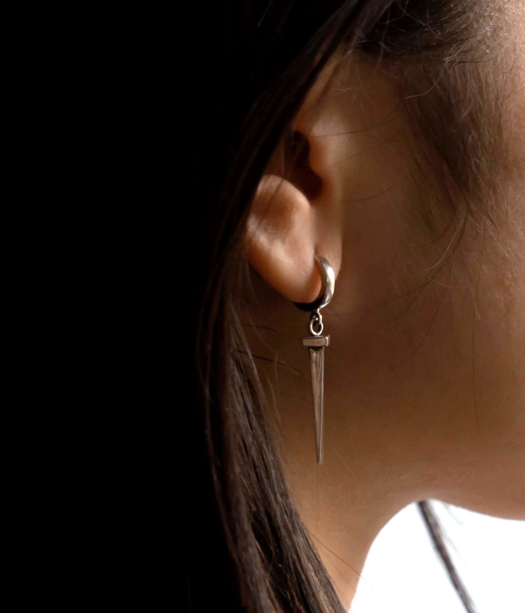 Tough as nails sterling silver earring on model shot close up 