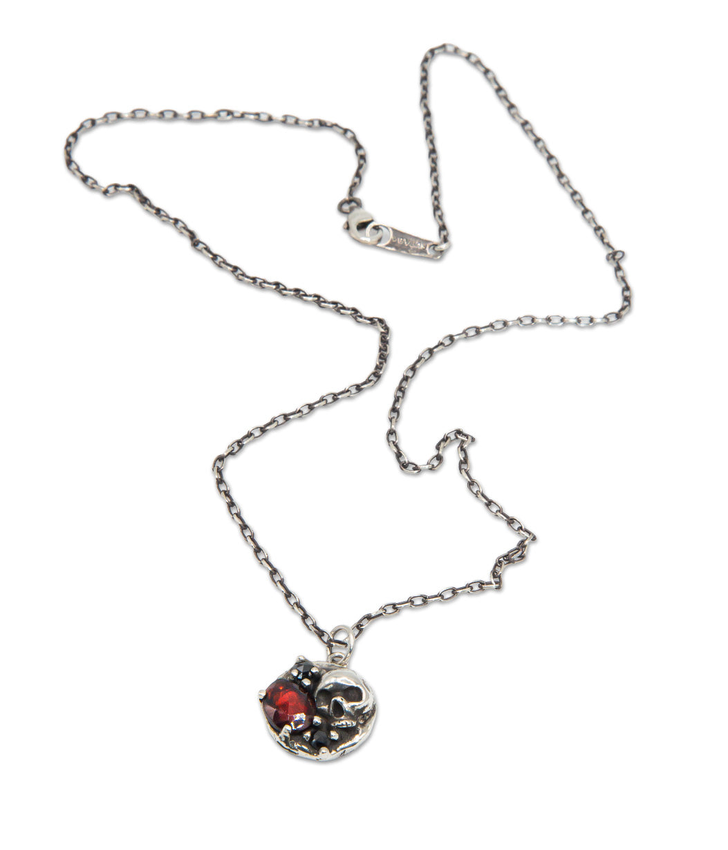 Necklace with a skull and crossbones pendant on a white background