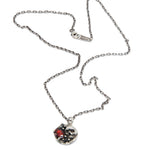 Necklace with a skull and crossbones pendant on a white background