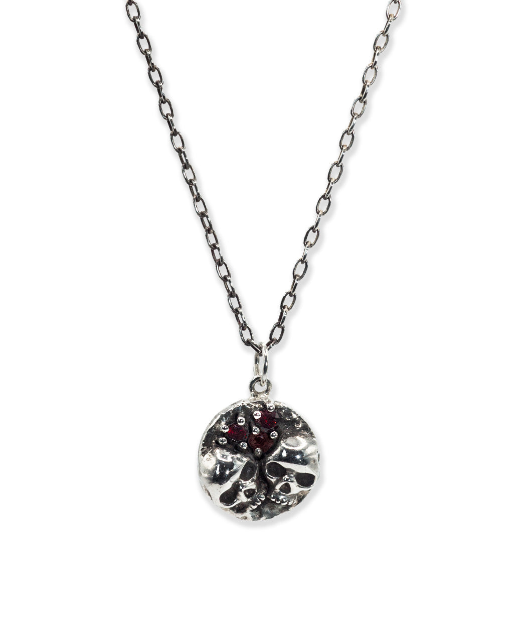 Silver necklace with a round pendant on a white background