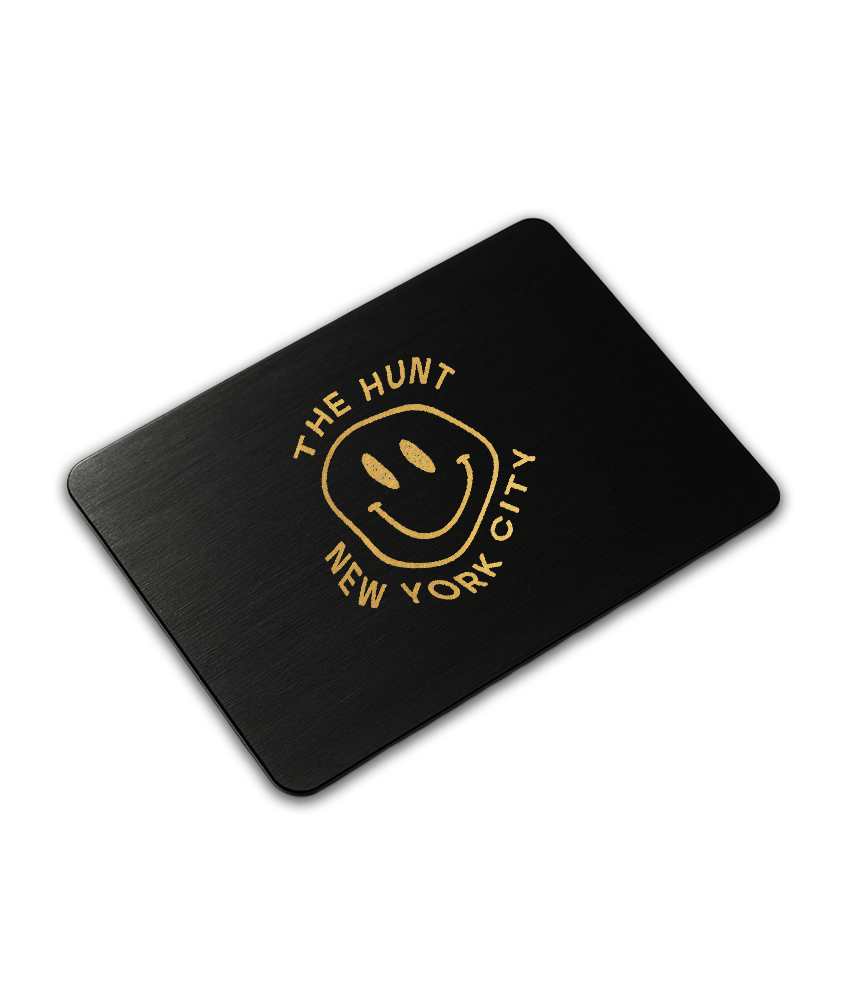 Black card with gold text and smiley face logo on a white background