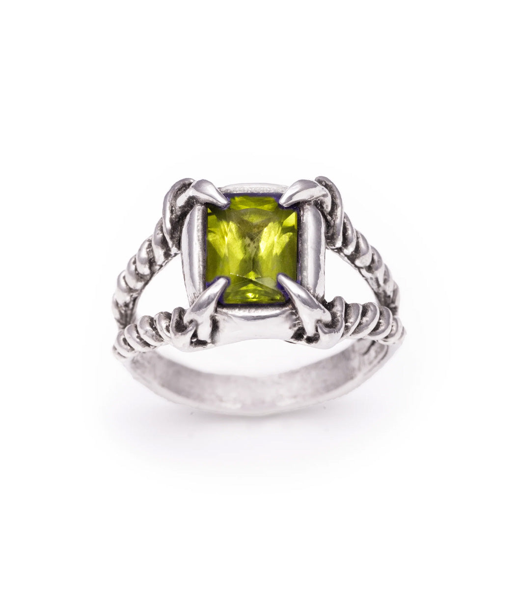 Silver ring with a green gemstone on a white background