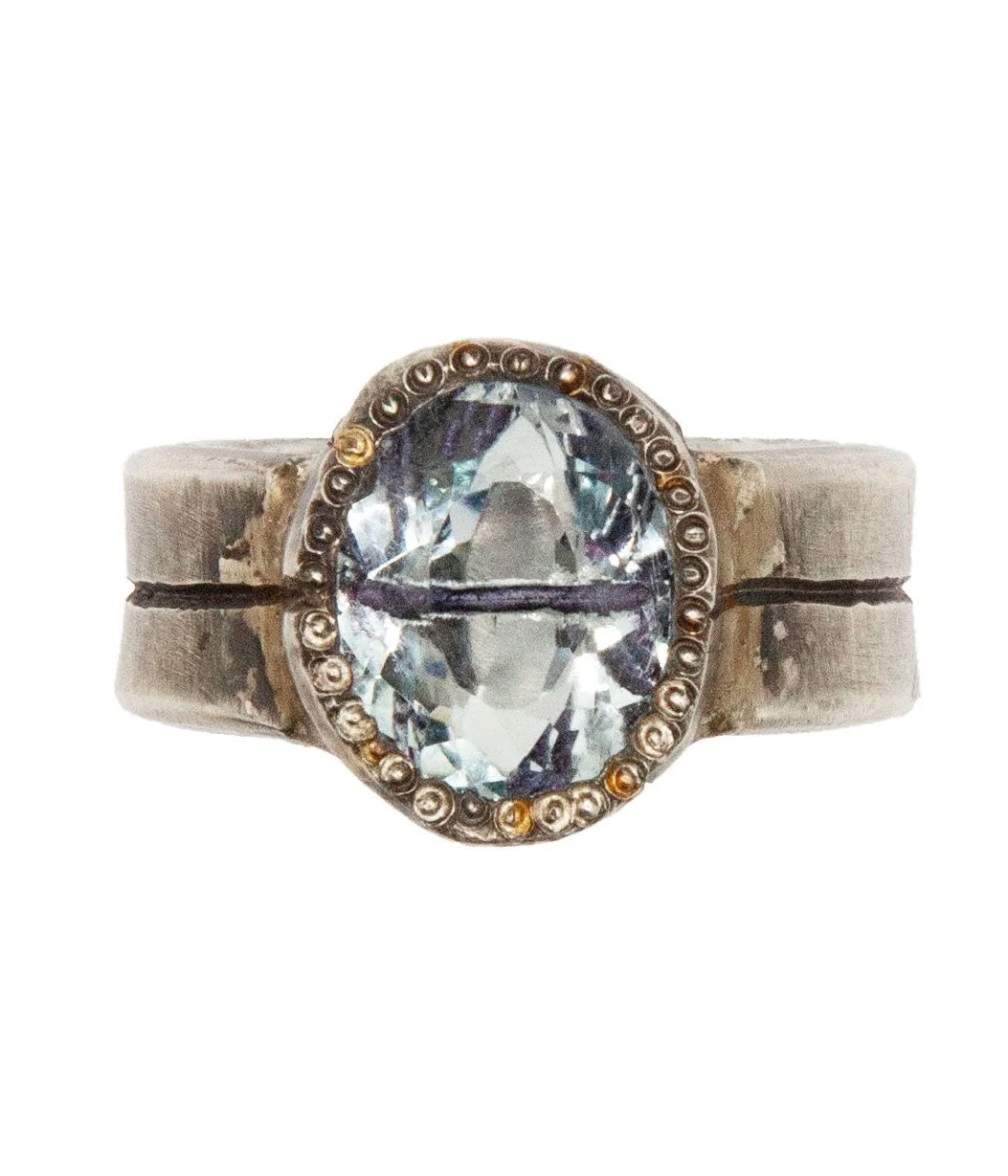 Silver ring with a large gemstone on a white background