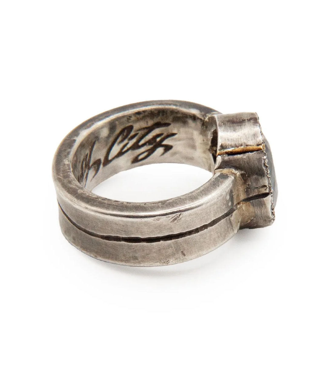 Silver ring with 'W. City' engraving on a white background