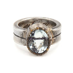 Silver ring with a blue gemstone on a white background