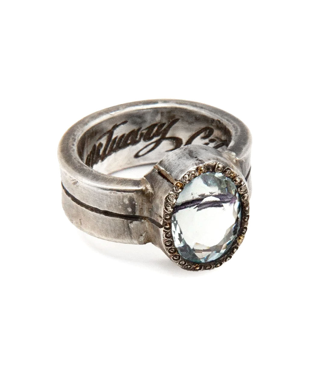 Silver ring with a large gemstone on a white background