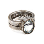 Silver ring with a large gemstone on a white background