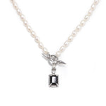 Freshwater pearl necklace with a square black onyx pendant and silver spike toggle closure