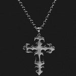 Silver cross pendant necklace on a black background